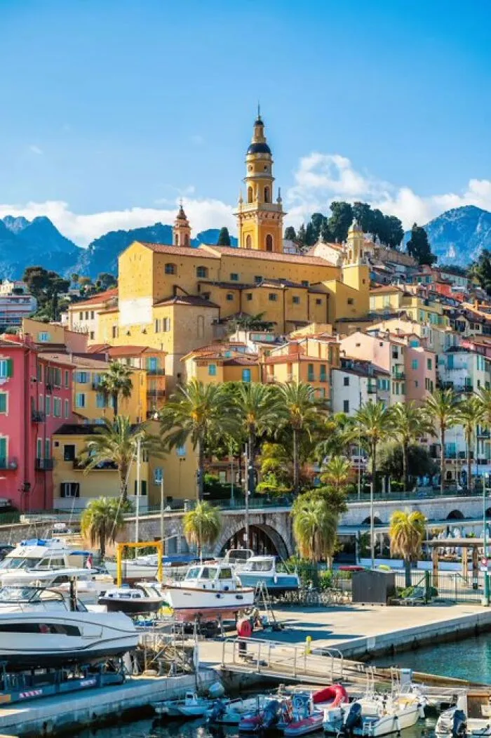 Picturesque harbor town with colorful buildings and a prominent clock tower, displaying buildings with so much character.