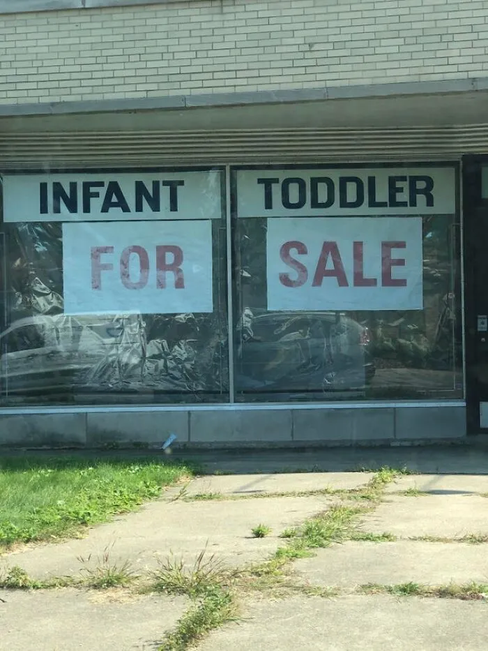 A hilariously bad ad placement on a store window reads INFANT FOR and TODDLER SALE.