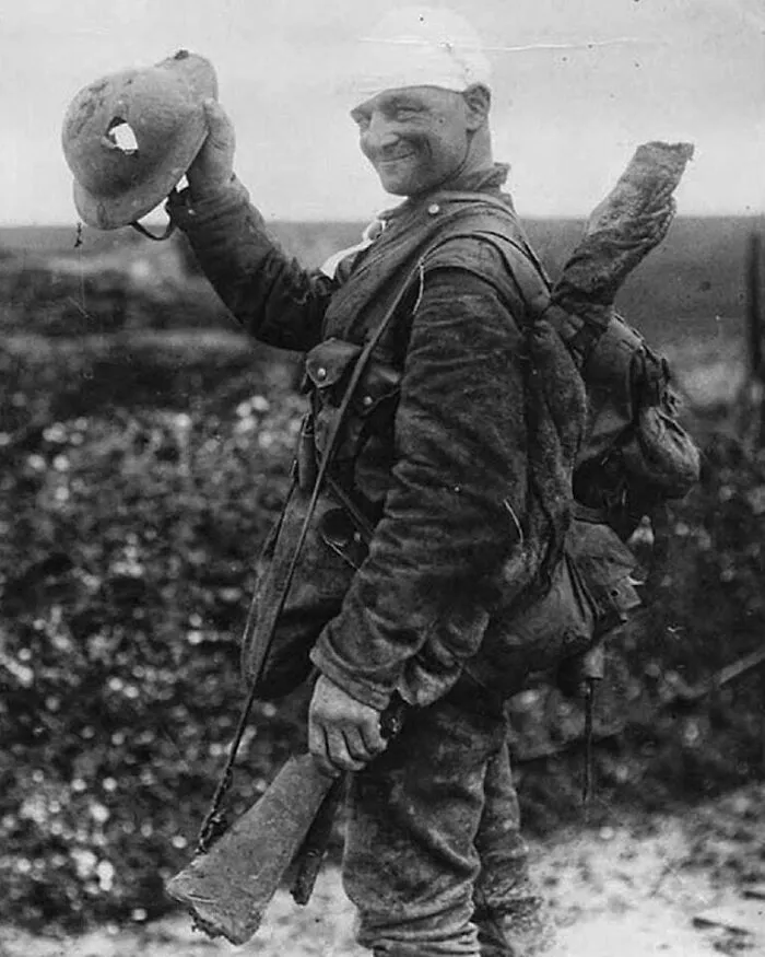 Lucky British Soldier Shows Off His Damaged Helmet, 1917