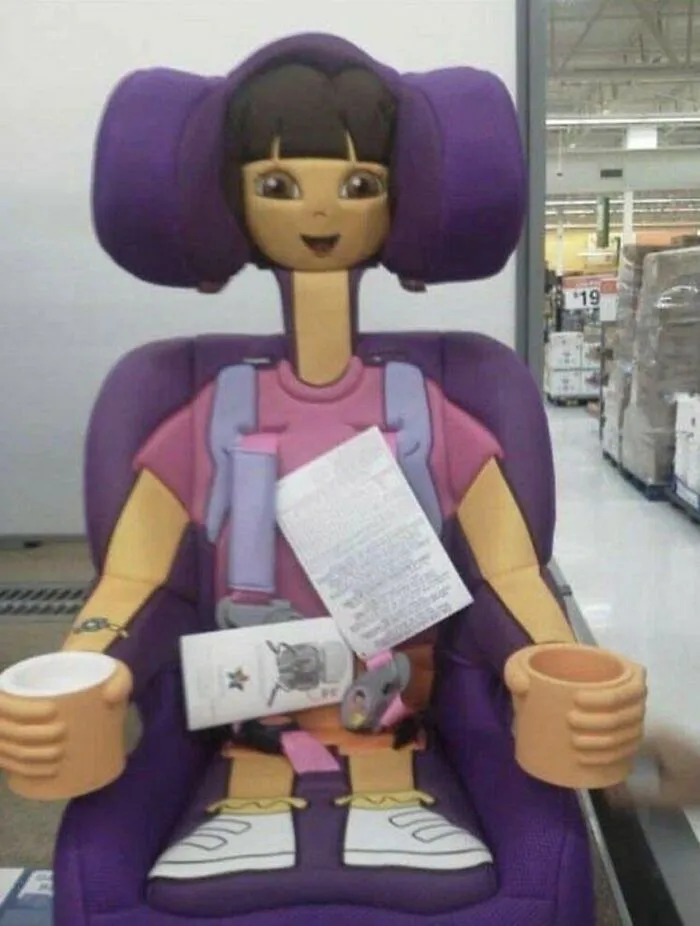 A Dora the Explorer themed car seat, looking unsettlingly like a stuffed doll, one of the cursed images.