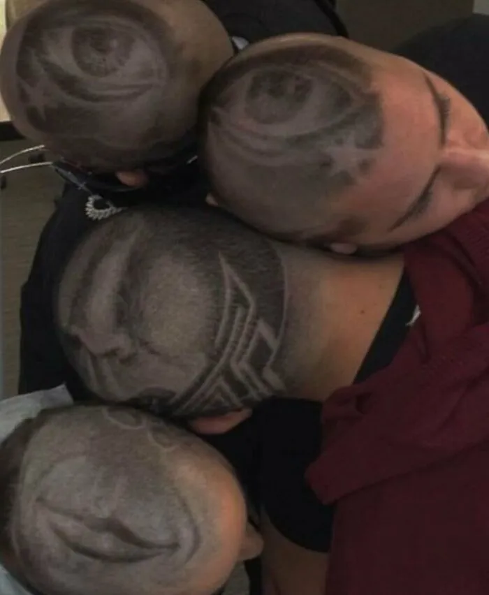 Four individuals with bizarre shaved designs on their heads, creating cursed images.