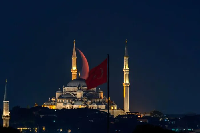 Murat Bakmaz captures the easily missed beauty of a mosque at night with a full moon and Turkish flag.