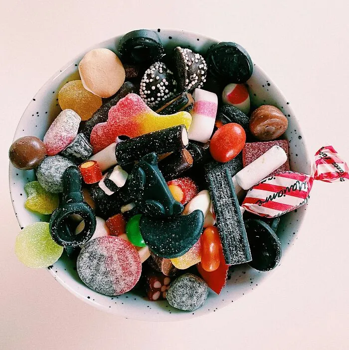A bowl of colorful candies and sweets, representing harmless habits that can destroy people in their later years.