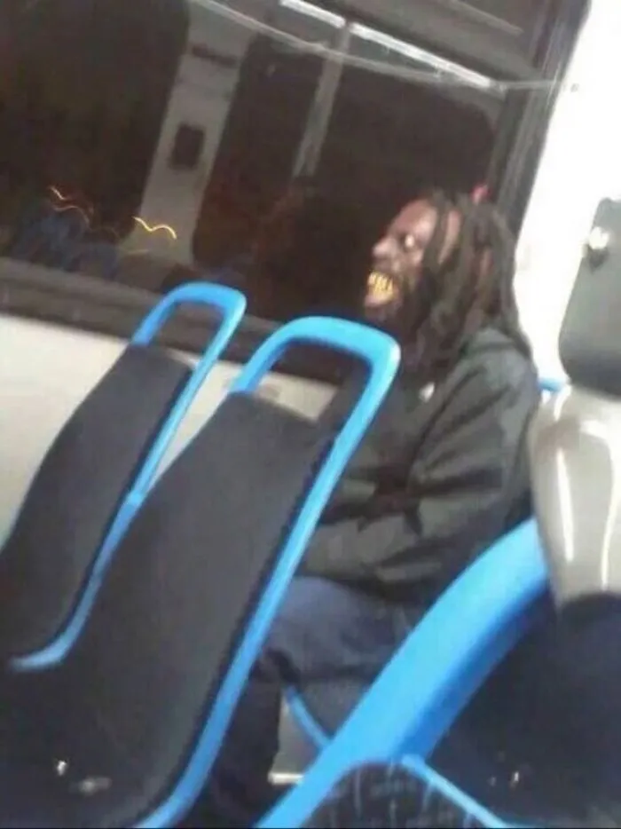 Unsettling photos of a person with dark dreadlocks and gold teeth, looking unnervingly in a bus seat.