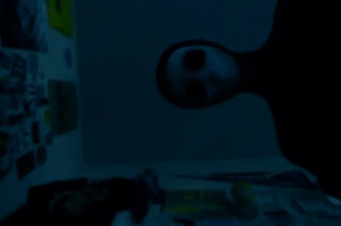 Unsettling photo of a shadowy figure with hollow eyes staring down, making it one of the most unsettling pictures.