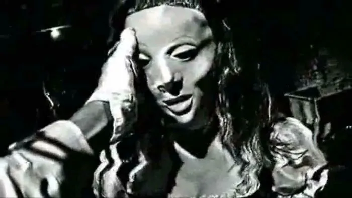 Unsettling photos of a person wearing a pale, unsettling mask in a dark, grainy image.