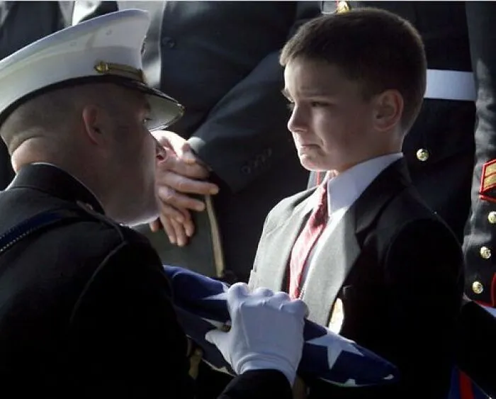 8 Year Old Christian Golczynski Receiving The Flag From His Fathers Military Funeral Is The Most Haunting In My Mind