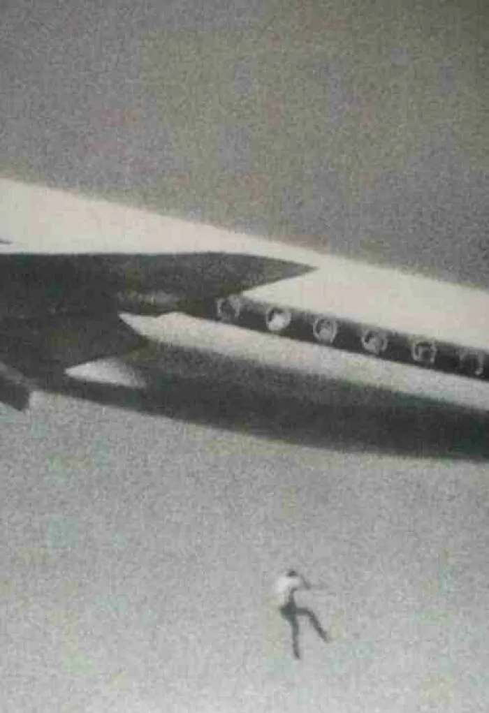 Unsettling photos of a person falling from an airplane high above the ground.