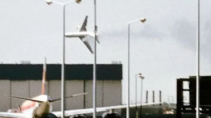Unsettling photos: An airplane is seen upside down in the sky over an airport, a truly unsettling picture.