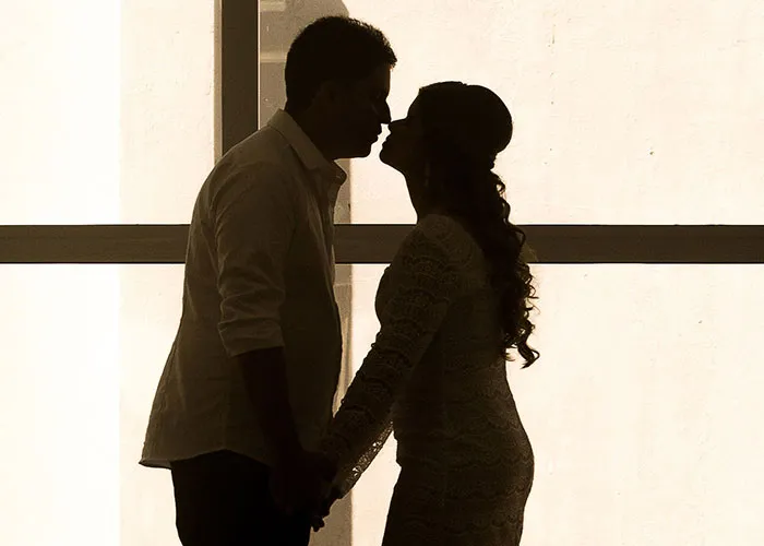 A silhouette of two people about to kiss, capturing a romantic moment that could be a cringe midlife crisis.