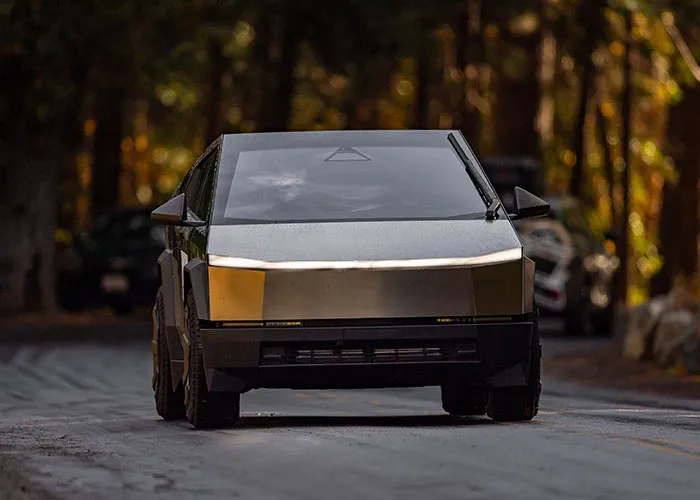 A futuristic black car on a road, representing a drastic change or purchase associated with a midlife crisis.