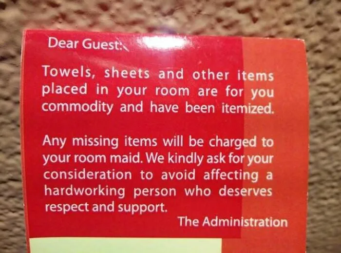 A sign from hotel administration about missing items charged to the room maid, highlighting a sad world situation.