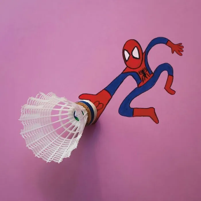 A badminton shuttlecock used as a spiderweb shooter in a playful illustration of Spider-Man.