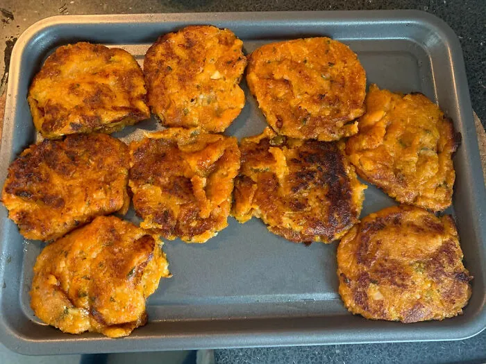 Failed cooking attempt with burnt orange patties on baking tray