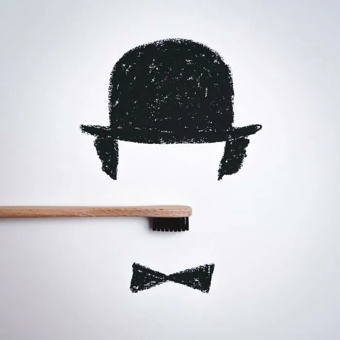 A playful illustration of Charlie Chaplin made with a wooden toothbrush and chalk sketches