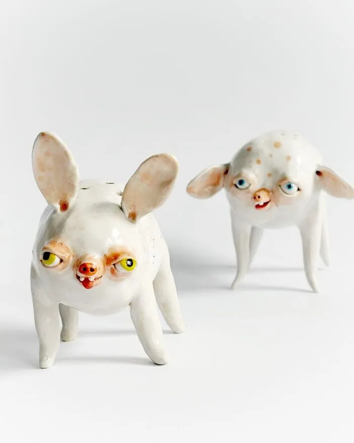 Two funny-looking four-legged weird ceramic sculptures designed as home decor