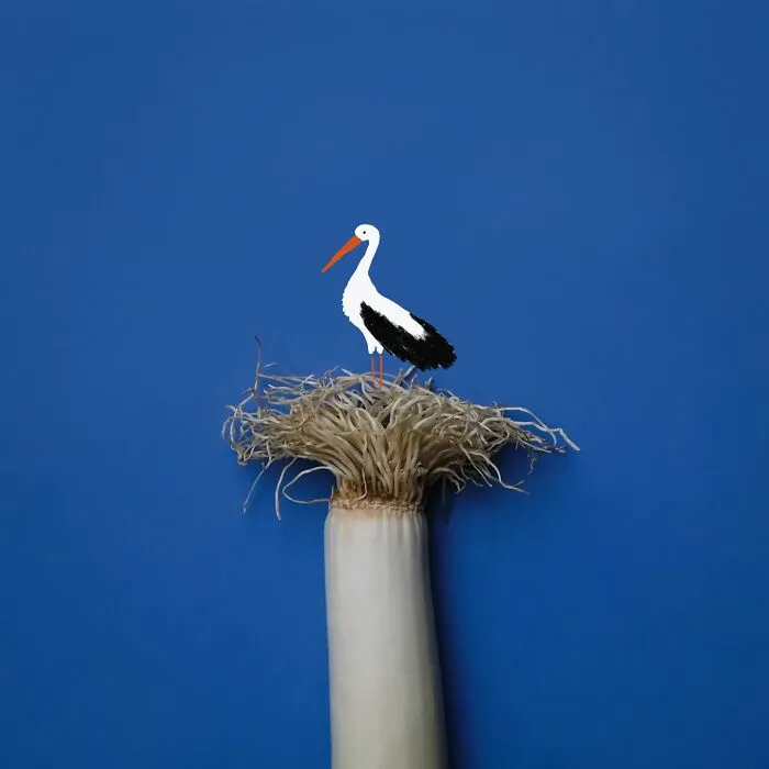 A playful illustration of a stork nesting on a leek, showing everyday objects coming to life.