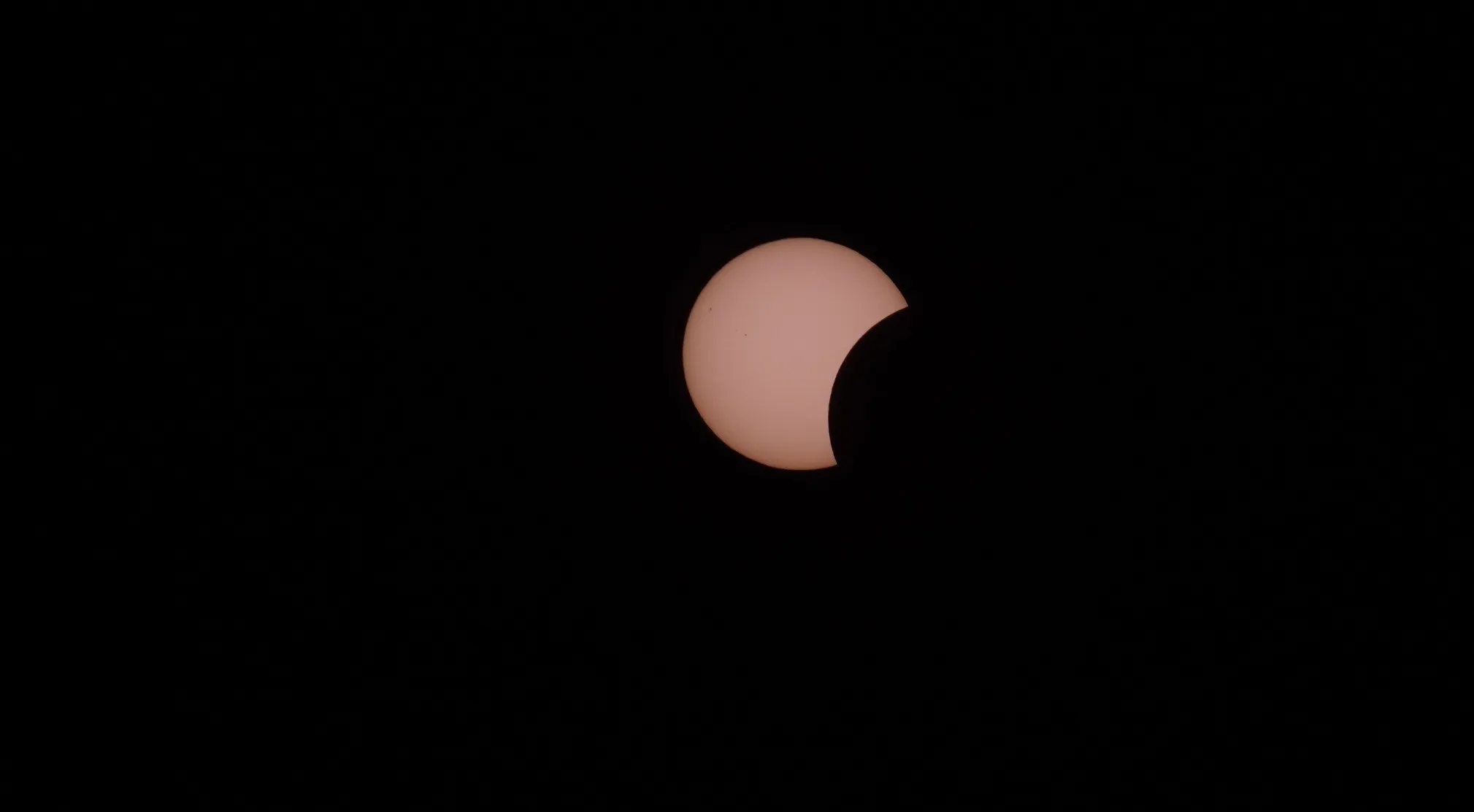 Partial solar eclipse against a dark sky. UFO and Conspiracy Theories Trivia.
