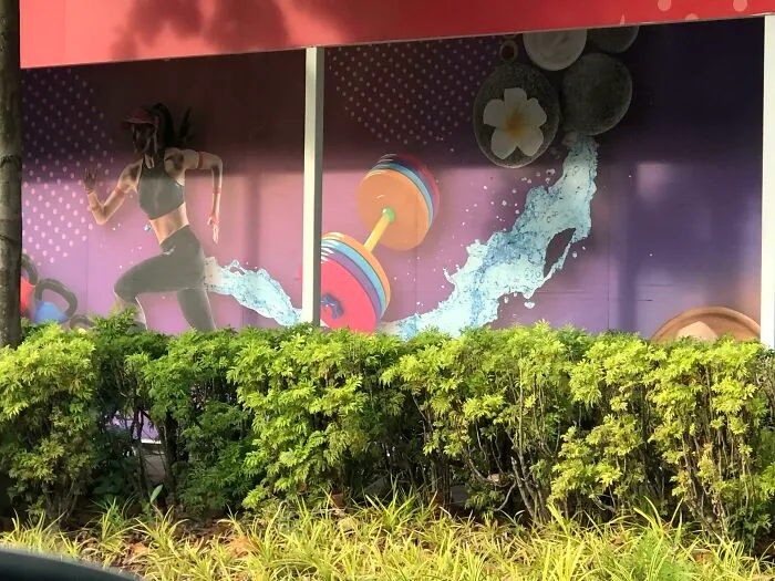 A dynamic gym ad placement features a running woman, a dumbbell, and a splash of water, creating a hilarious ad placement.