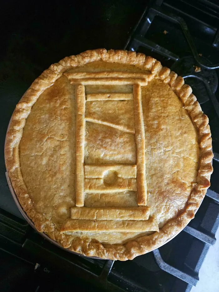 A pie with a guillotine design on top, representing Eat The Rich moments.