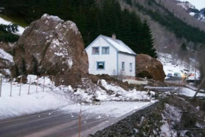 This House In Norway Where A 89-Year Old Woman Lived Was In The Direct Path Of A Rockslide In 2004. Somehow The Two Largest Boulders Deviated Just Enough From Their Paths To Narrowly Miss Her House, On Each Their Side! She Was Inside, Sleeping At The Time
