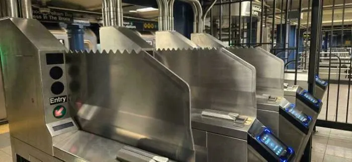 Subway turnstiles represent the horrid world, showing the daily commute and urban struggles.