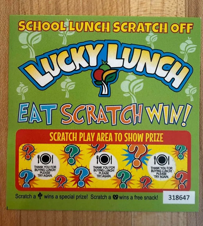 A School Lunch Scratch Off lottery ticket, symbolizing aspects of the horrid and sad world.