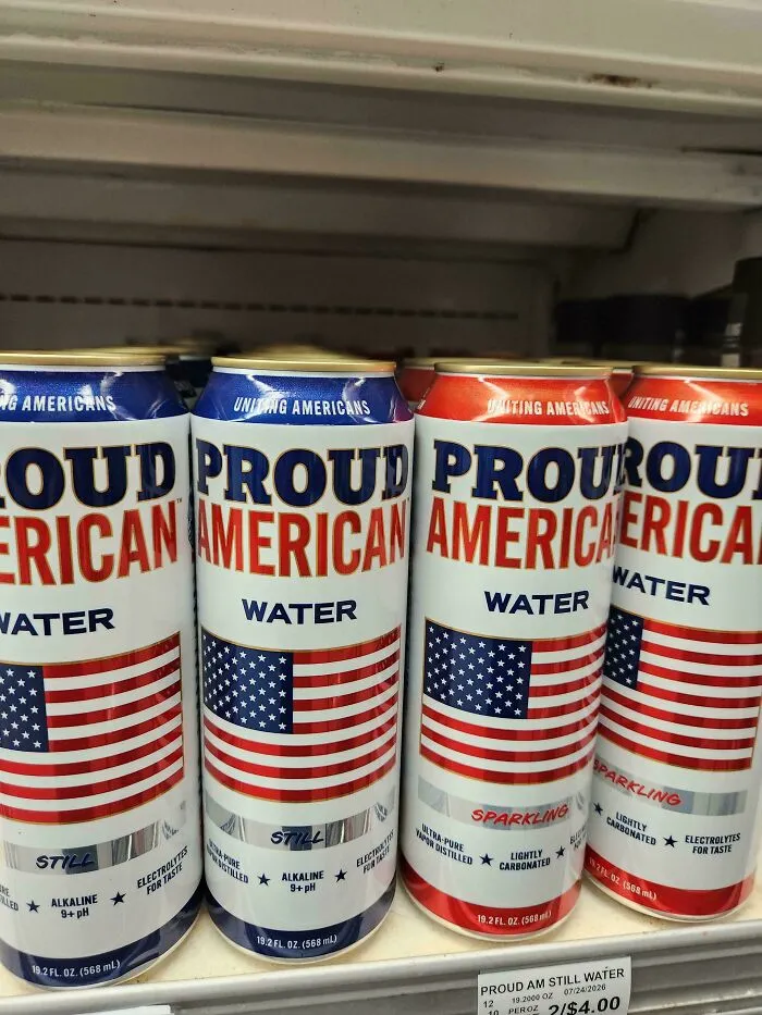 Cans of canned water lined on a shelf, an odd choice among questionable food combos.
