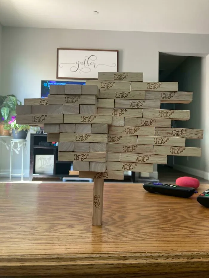 An Entire Box Of Jenga Stacked Asymmetrically On One Jenga Block
