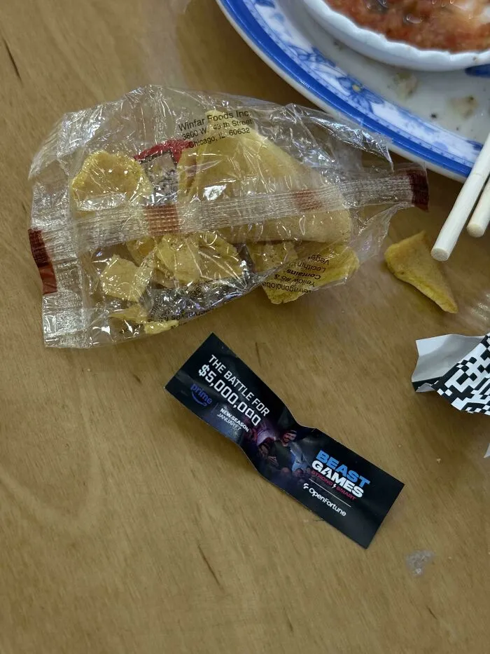 A fortune cookie package and a Prime Gaming ad, suggesting the American Dream might be a dystopian nightmare.