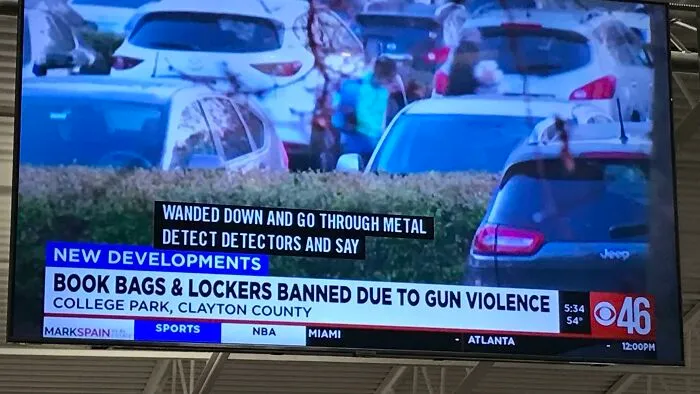 A TV screen showing a news report about book bags and lockers banned due to gun violence, depicting a dystopian American Dream.
