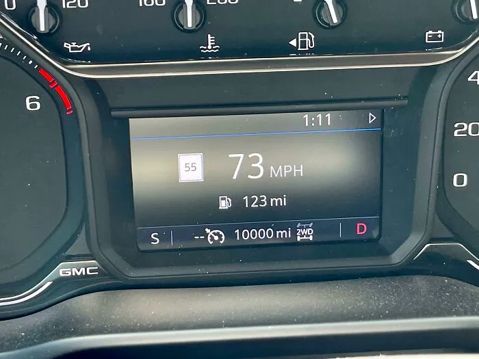 Car dashboard displaying 73 MPH and exactly 10,000 miles, a moment synced just right.