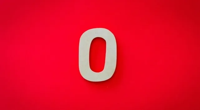 A single beige number zero stands against a vibrant red background, representing the zeros in a trillion for General Knowledge Quiz.