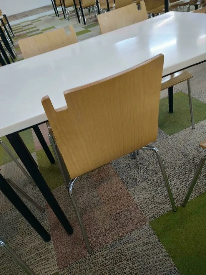 This Chair In An Office Cafeteria Has A Notch To Hang Bags