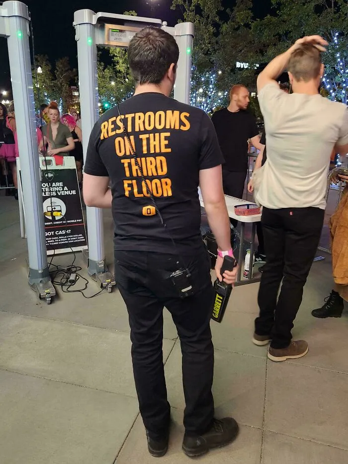 The Employees At This Venue Have The Location Of The Restroom On Their Shirts