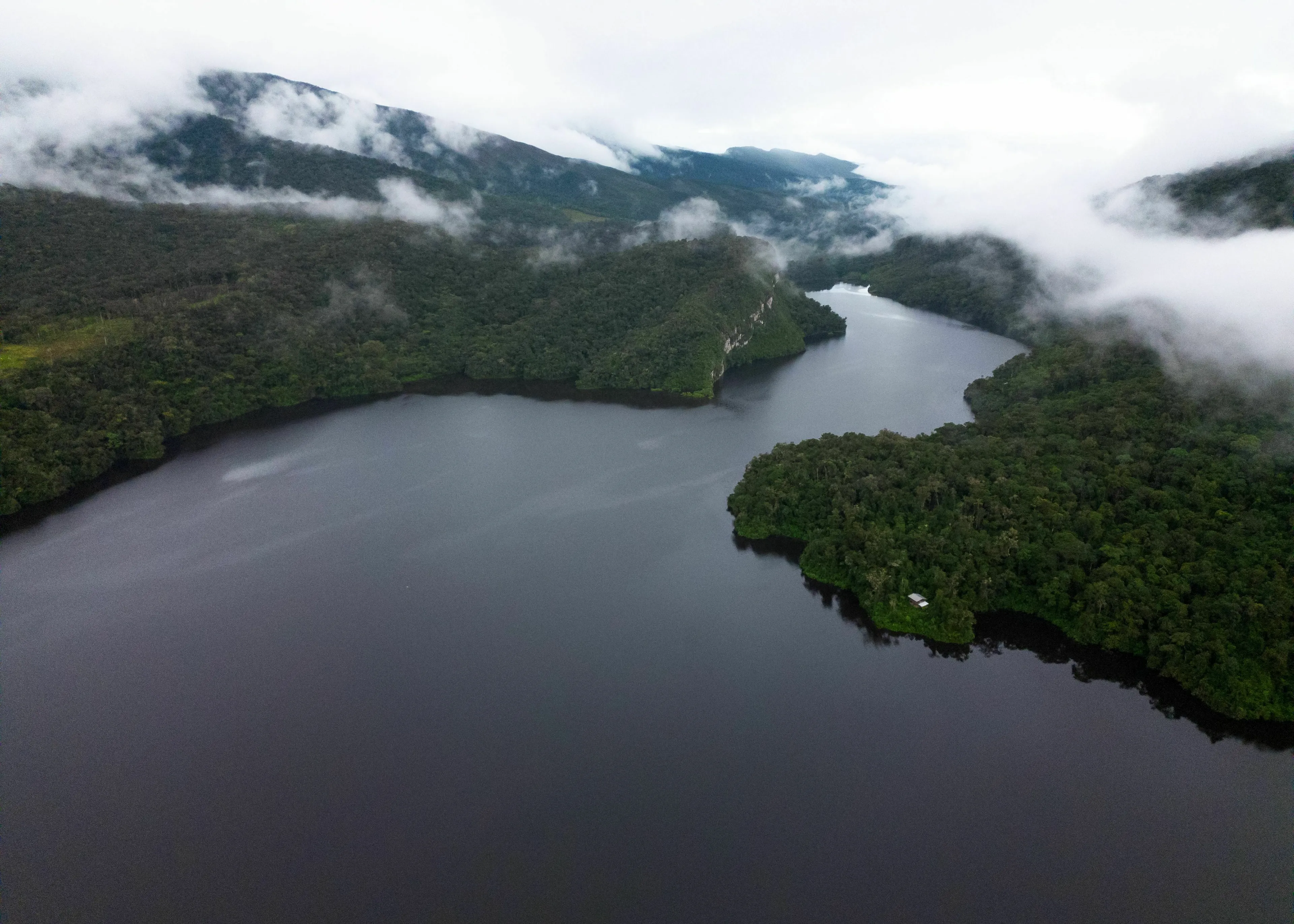 Misty South American river flowing through lush green mountains, featured in a geography quiz about longest rivers.