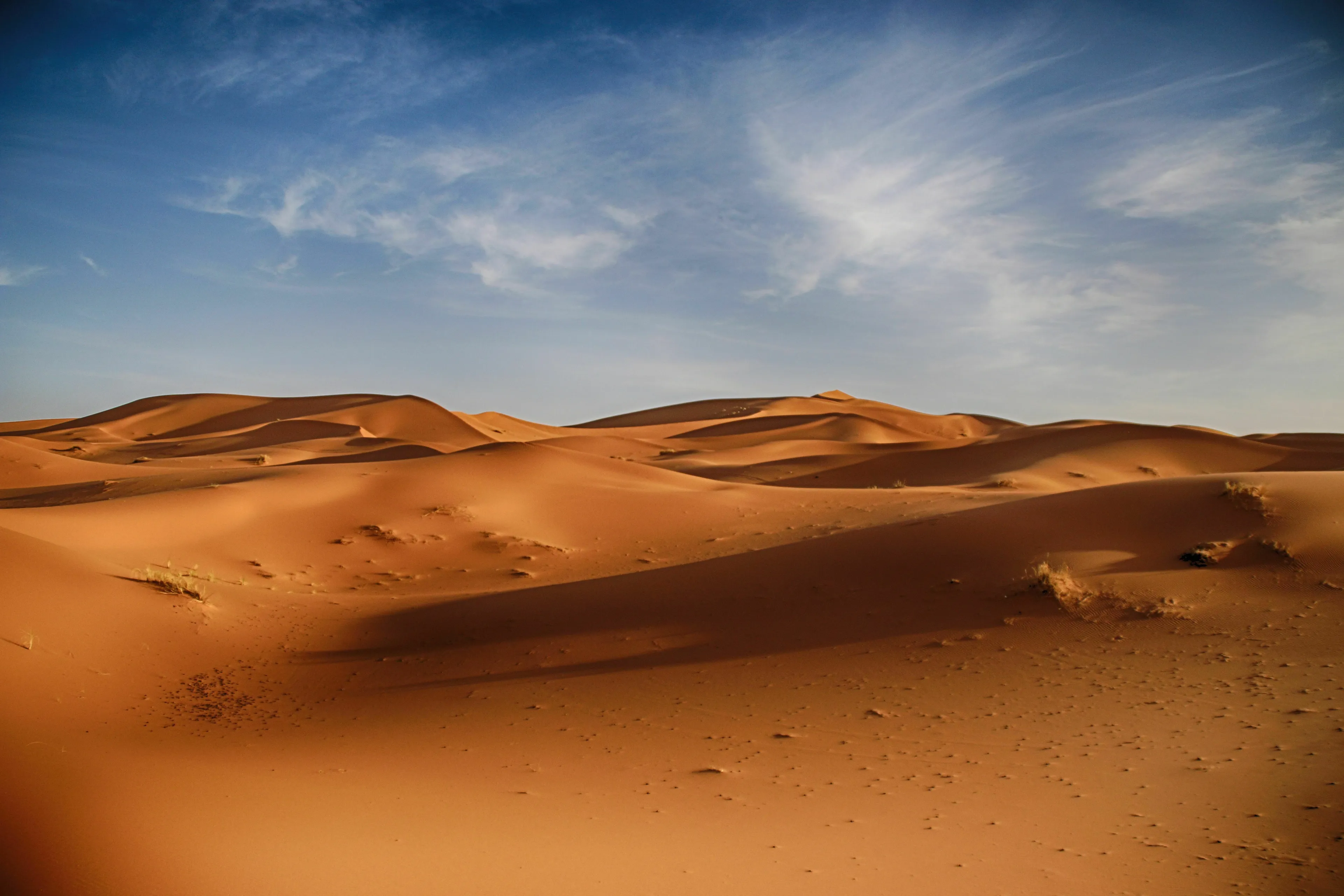Part 3 General Geography Knowledge Quiz, vast desert landscape with numerous sand dunes under a clear blue sky.