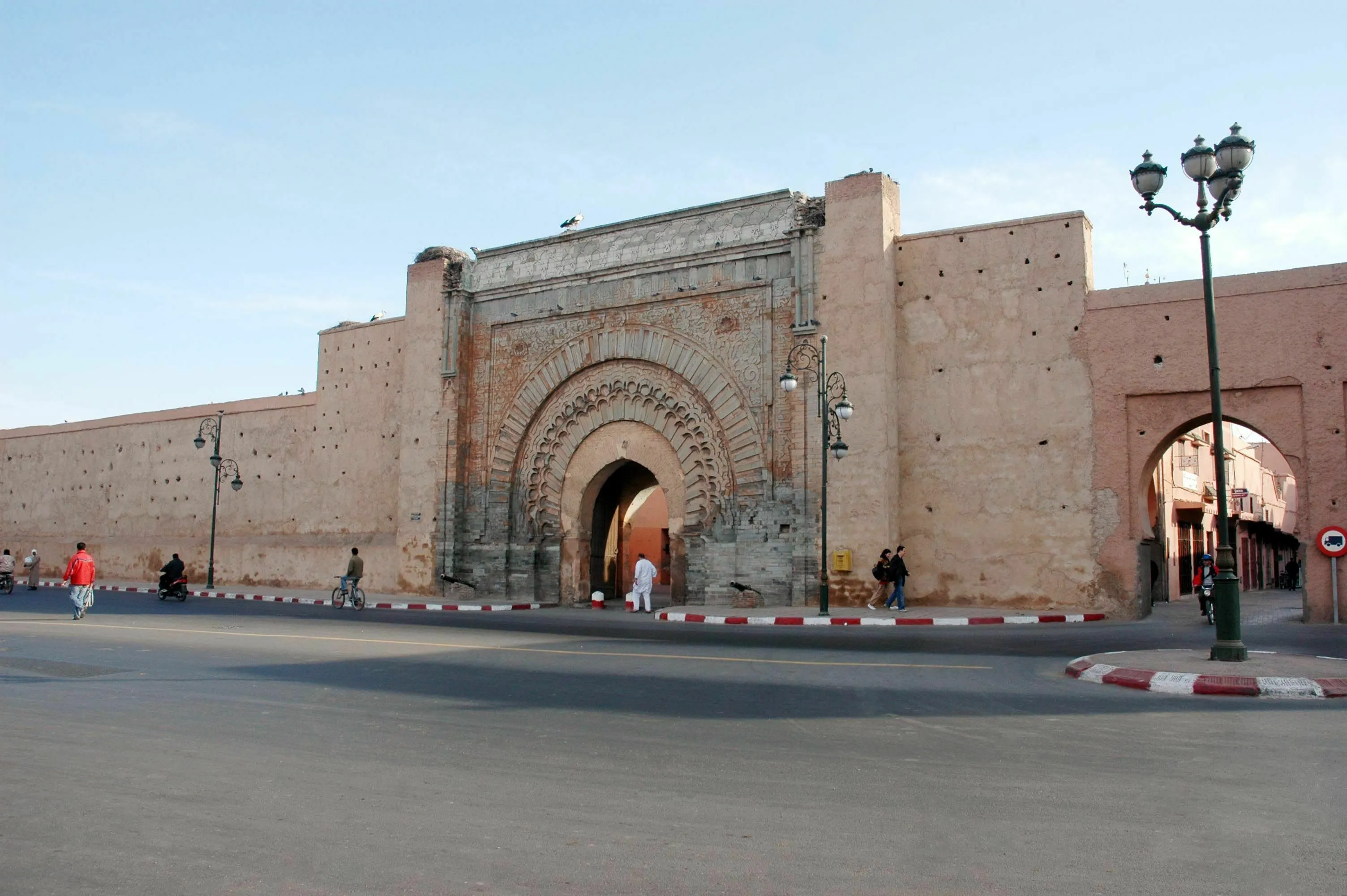 General Geography Knowledge Quiz: A large, ancient gate in Marrakech, Morocco, with people walking and cars on the street.
