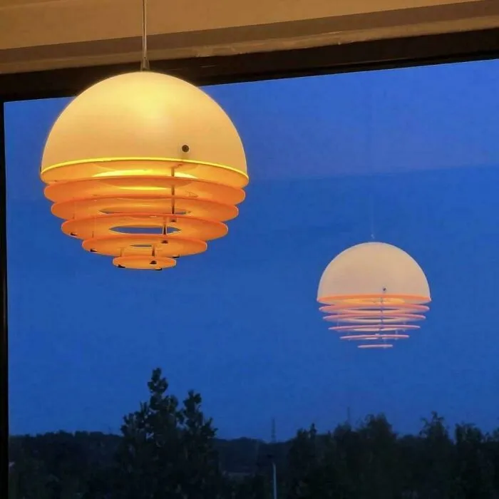 The Reflection Of This Sunset Lamp On A Glass Window Looks Magical