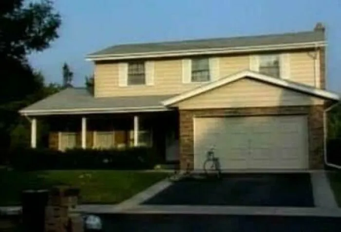 Gen X childhood nostalgia image of a two-story suburban house with a bike on driveway