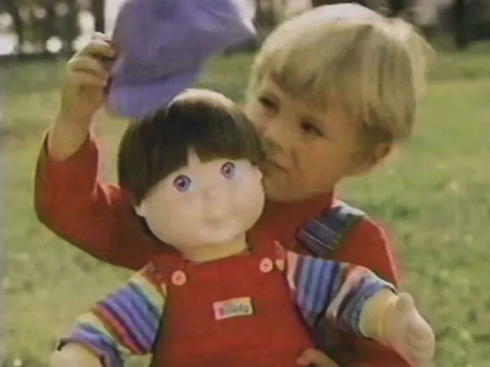 Child holding vintage doll toy representing Gen X childhood memories