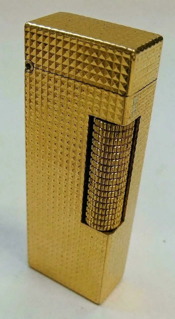 Vintage gold patterned lighter collectible representing Gen X childhood items