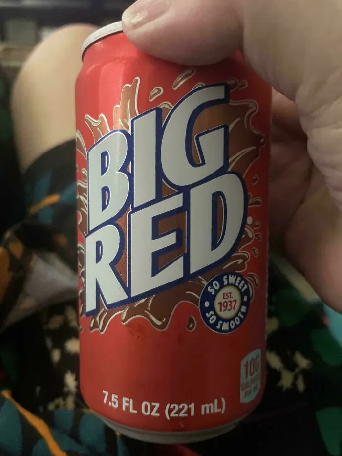 Hand holding a can of Big Red soda popular in Gen X childhood