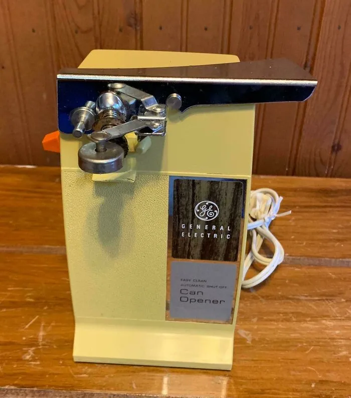 Vintage General Electric electric can opener on wood surface