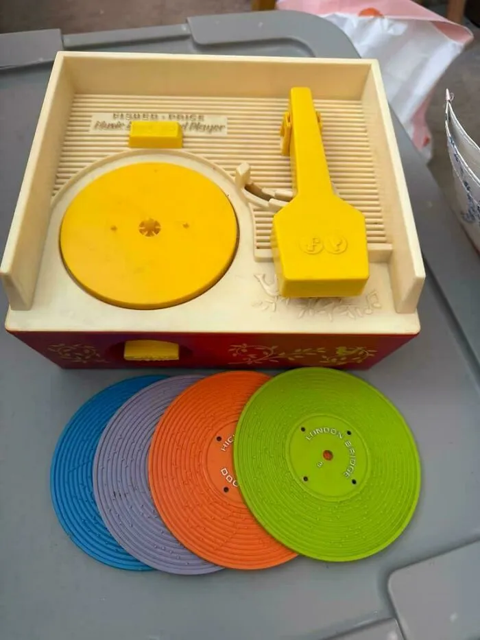 Retro childrens Fisher Price record player toy with colorful plastic discs