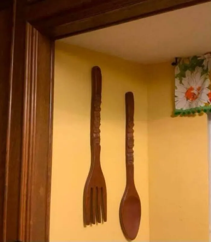 Vintage wooden fork and spoon wall decor in kitchen corner