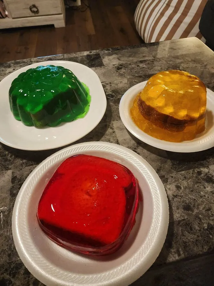 Questionable food combos showing three plates with slices of bread encased inside bright gelatin molds.