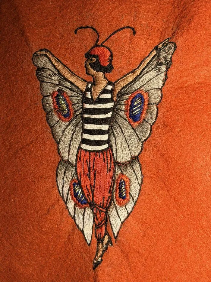 Vintage butterfly girl design hand-stitched onto orange felt as one of many creative embroidery projects