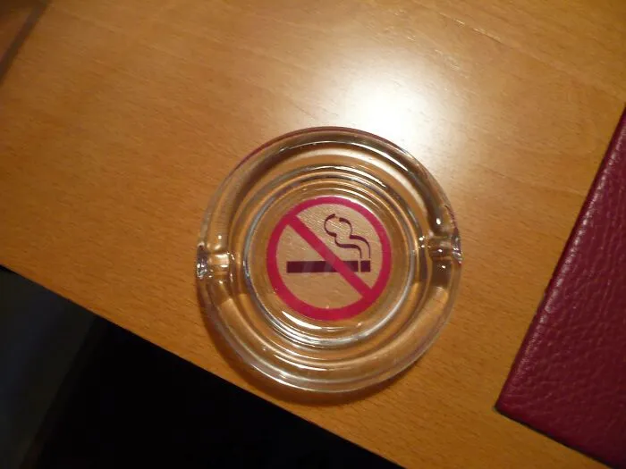 No smoking sign in ashtray on hotel room desk fail