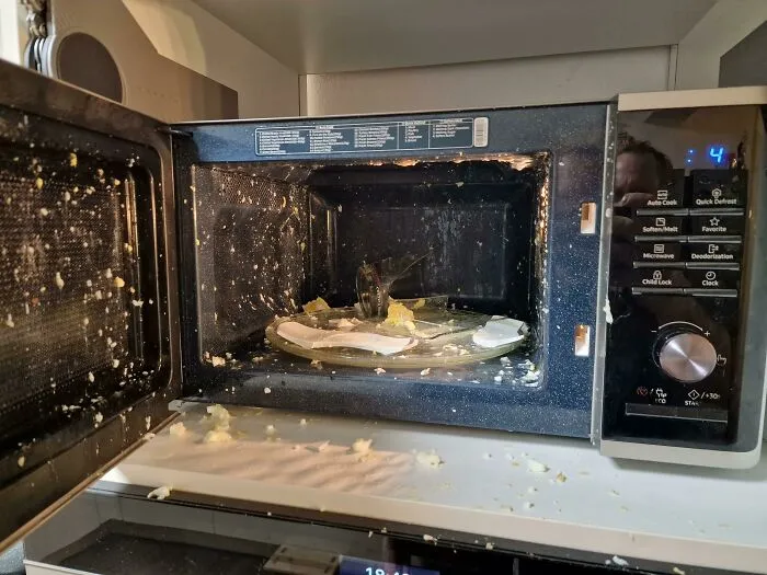 Microwave exploded with food splattered inside and outside